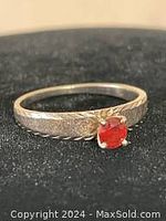 Front view showing red gemstone and band
