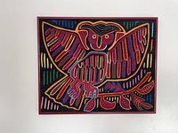 Frontal view of the framed Mola textile art with owl design showcasing whole artwork and frame.