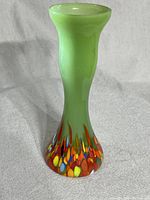 Full front view of the vintage green jadeite vase showing the colorful speckled base pattern.