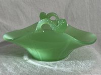 Side angled view showing overall shape and dolphin koi handles