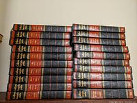 Two stacked views of the encyclopedia and year book volumes, showing the spines and quantity.