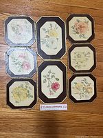 Set of 8 floral-themed board trivets, various rose floral designs with fabric backing, two larger and six medium-sized pieces shown flat on floor