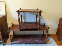 Photo of stacked larger and smaller vintage tables showing turned posts and finials.