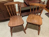 Mismatched pair of vintage wooden kitchen chairs showing front and side views with natural wood finish and turned legs.