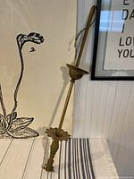 Full view of the antique brass ceiling light fixture showing its overall height and design mounted against wall.