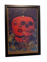 Framed Richey Beckett print showing red dual-faced figure (woman and skull) with blue and gold abstract background.