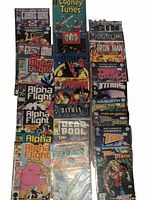 Full lot of 21 assorted comic books arranged on table, showing titles and condition.