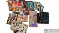 Photo of various collectible card packs and loose cards including James Bond 007 black and white cards, MTV Raps cards, anime-themed cards, and Vampire Bloodlines deck.