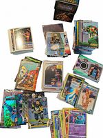 Overview of the lot showing multiple stacks of assorted collectible cards including WWE, Nintendo Power, football, and Yu-Gi-Oh cards with a Yu-Gi-Oh deck box on top