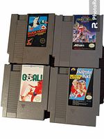 Four gray Nintendo NES game cartridges: Duck Hunt, Double Dragon, Goal!, and The Karate Kid, showing all front labels.