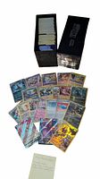 Photo showing over 150 reverse holo Pokemon cards displayed partially out of a black binder box labeled 'Evolutions'. Cards include both Pokemon and trainer cards, some with holographic and full art designs.