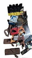 Photo showing an assortment of vintage saws, miter boxes, and wood hand planes.