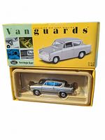 Front view of the 1:43 scale die cast Ford Anglia Super model car in original yellow and green Vanguards box showing the car model through plastic window.