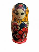 Close-up of the largest Matryoshka doll showing face and floral painted details on the body.