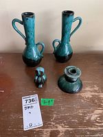 Four Blue Mountain Pottery ceramic pieces on wooden surface - two vases, owl figurine, and candle holder visible from front