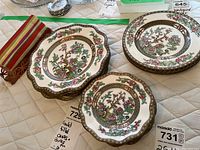 Photo showing the plates stacked and the metal napkin holder positioned horizontally