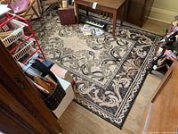 View of full area rug with visible floral and scroll pattern, showing size and design details.