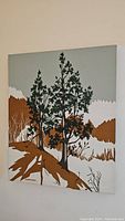 Front view of signed Marushka screen print on stretched linen, showing pine trees and landscape.