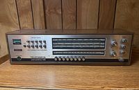 Front view of receiver showing tuning window, FM pushbutton controls and branding