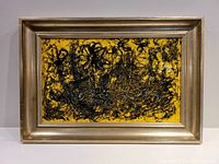 Framed abstract painting with yellow background and black textured paint, viewed frontally to show entire piece and frame.