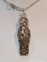 Front view of pendant and snake chain on white background