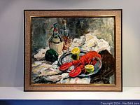 Framed oil on canvas painting with a still life of lobster on tray and bottles in background