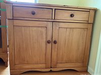 Front view showing two drawers and double doors