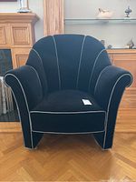 Front view of black upholstered armchair