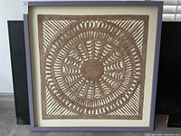 Front view of square framed brown paper cut-out on white background