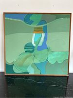 Full front view of square abstract painting in wood frame