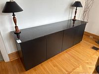 Full front view of credenza with lamps on top.