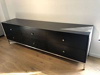 Front view of credenza showing overall design, finish, and chrome legs