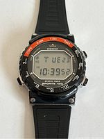 Front-facing view showing digital display, bezel markings and rubber strap