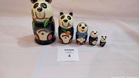 Full set of 5 Lucky Panda Nesting Dolls arranged in size order from largest to smallest.