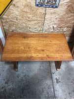 Top view of the rectangular wooden table showing the surface wear and grain pattern.