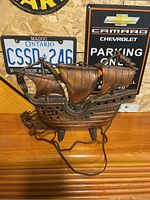 Full view of the cast bronze sailing ship lamp showing three sails and detailed hull on metal base, includes power cord.