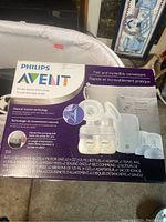 Full box of Philips Avent double electric breast pump showing pump components and bottles on front.