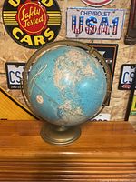 Front view of vintage globe showing North America and details including USSR on map