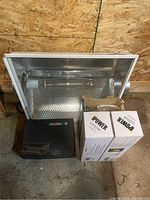 Full set showing the Silver Star reflector hood, two boxed IPOWER 1000W bulbs, and the NROLUX ballast on a concrete floor.