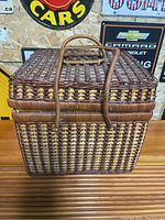 Closed wicker picnic basket showing woven pattern and handle