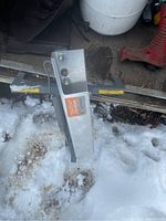 Chantion High Fly skeet thrower device positioned on snow with visible mechanical parts and label.