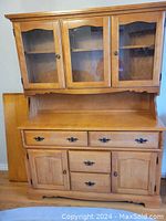 Front view of entire hutch and buffet set, showing pine wood finish and glass doors on hutch.