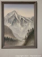 Full view of the framed monochromatic oil painting showing a large mountain with trees in foreground and a misty background.