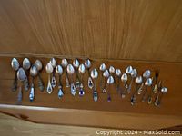 Overall view of spoons laid out on wooden shelf