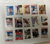 Top side of 15 Wayne Gretzky hockey cards in various poses and jerseys, laid out on a flat surface.
