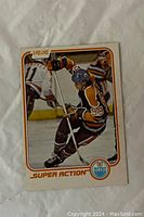 Front of the 1981-82 O-Pee-Chee Wayne Gretzky hockey card #125 showing Gretzky in Edmonton Oilers uniform celebrating with stick raised.