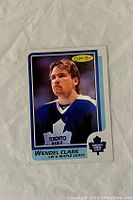 Front of the 1986-87 O-Pee-Chee Wendel Clark rookie card showing player's photo in Toronto Maple Leafs jersey, O-Pee-Chee logo, and card details.