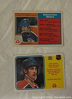 Front of first card showing Wayne Gretzky in Edmonton Oilers helmet with yellow background