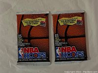 Front view of two sealed 1991-92 NBA Hoops basketball card packs, each marked with basketball image and series info