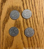 Four Canadian 5 cent nickels showing reverse side with the denomination 'FIVE 5 CENTS' and years 1930, 1931, 1932, 1934 along with maple leaf design.